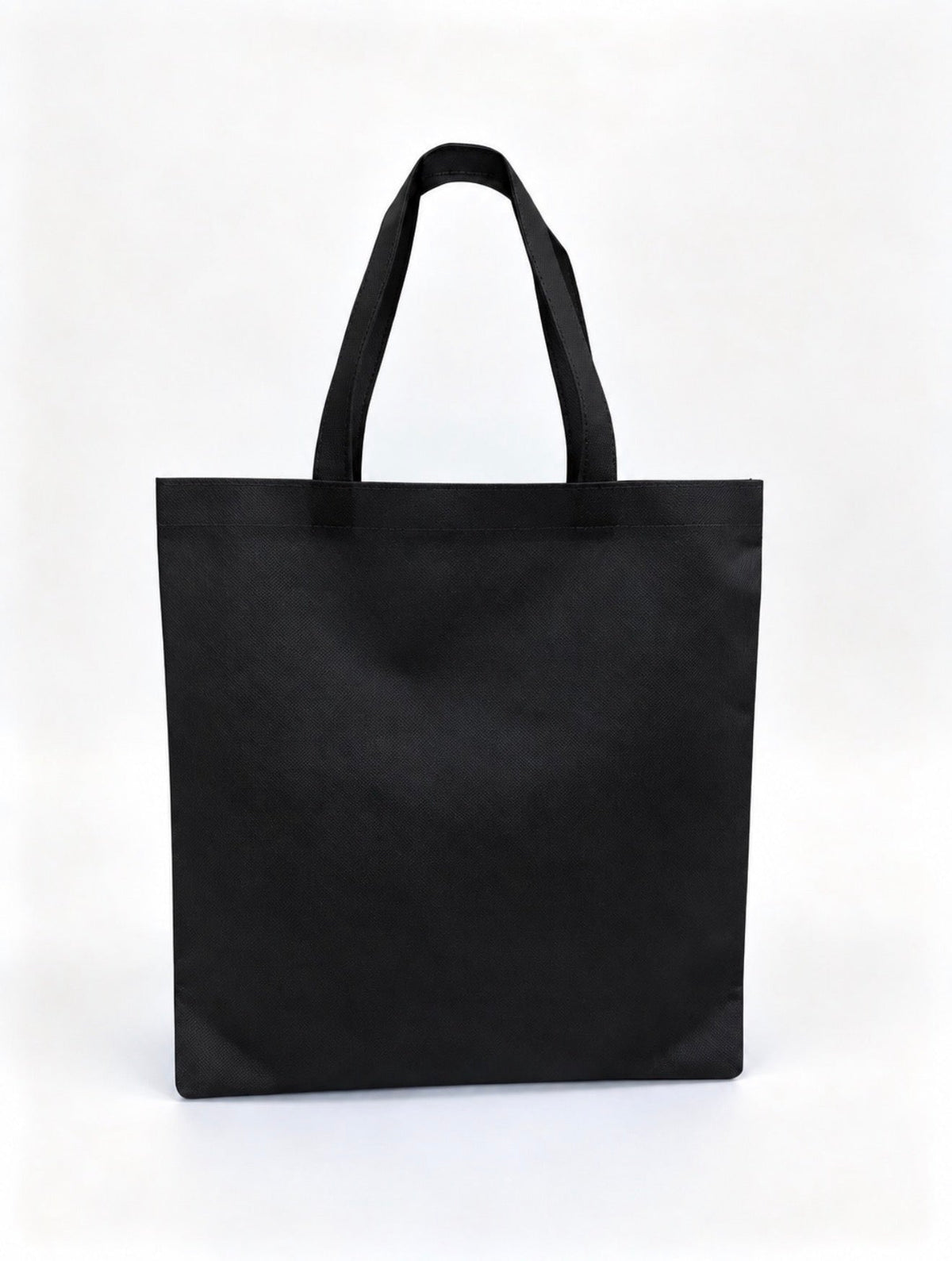 Plain black non-woven tote bag with long handles, 15 × 16 inches
