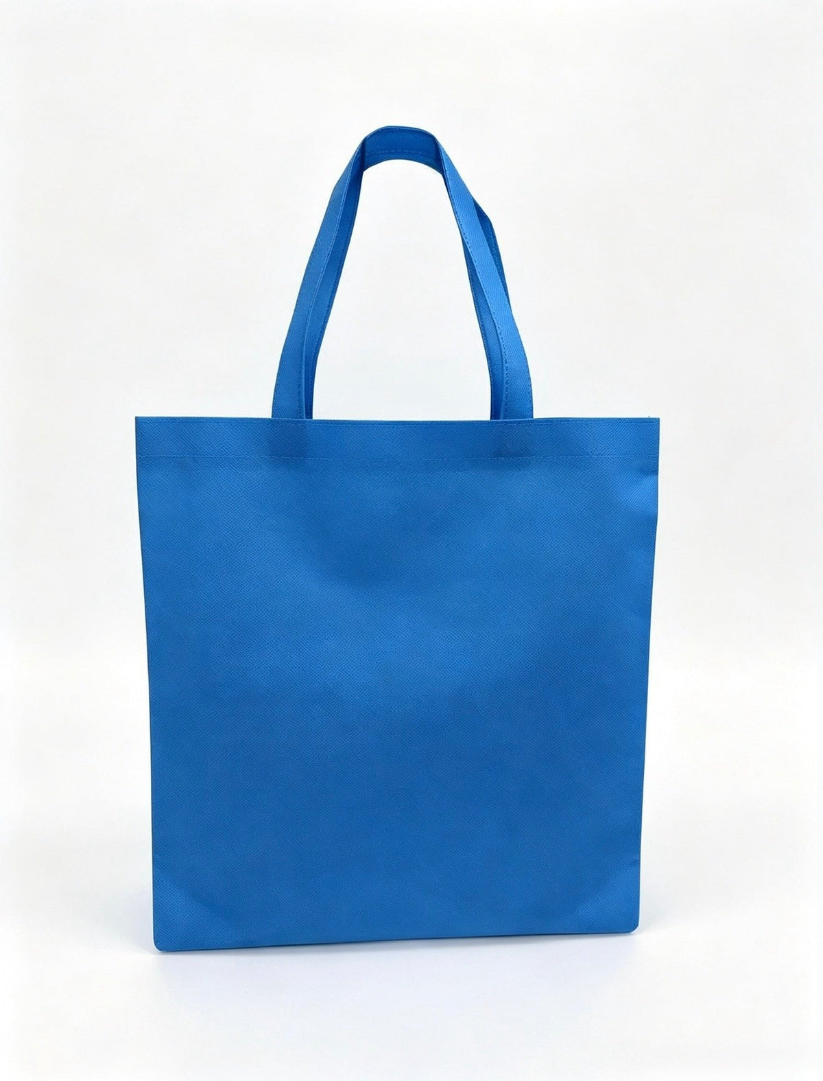 Plain blue non-woven tote bag with long handles, 15 × 16 inches